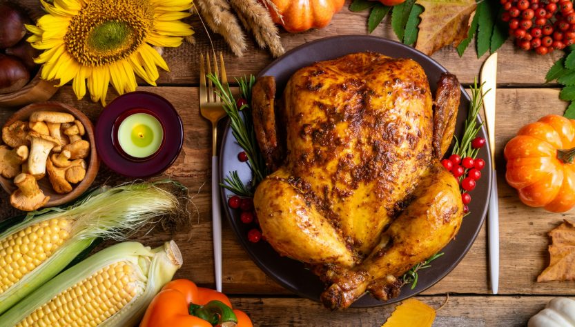 Baked chicken for Thanksgiving Day. Roasted whole chicken or turkey with autumnal vegetables