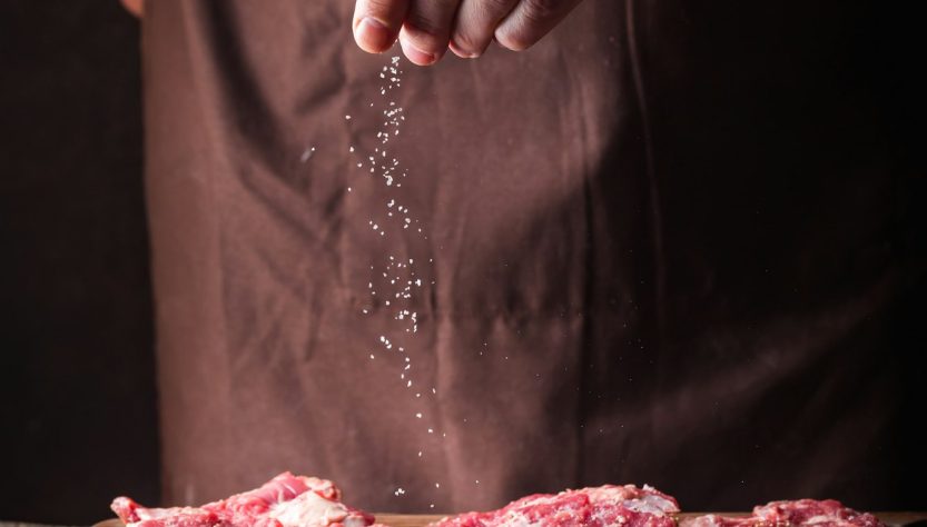 Man cooking meat steaks